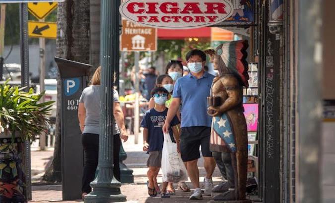 People wait to access a cigar store in Miami Dade, Florida, U.S., June 29, 2020