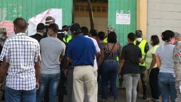 People crowd at a polling station's entrance, Santo Domingo, Dominican Republic, July 5, 2020.