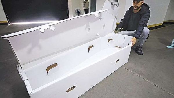 A public official showing a cardboard coffin, Santa Cruz, Bolivia, July 15, 2020.