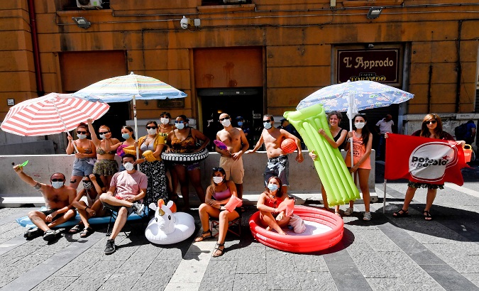 People gather outside the headquarters of Campania region to protest against the higher prices to access beaches in Naples, Italy, 28 July 2020.