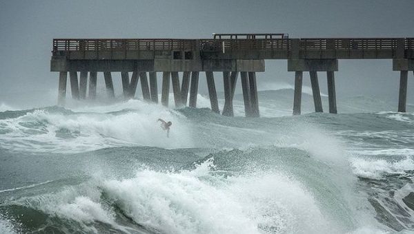 A man surfers the storm-derived waves in North Carolina, U.S., July 3, 2020.
