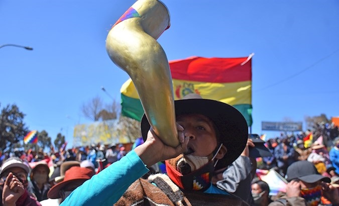 Citizen makes noise with a horn during protests, El Alto, Bolivia, August 14, 2020.