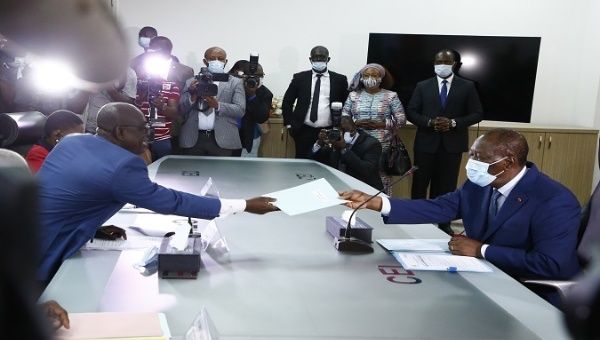  Ivory Coast's President Alassane Ouattara (R) submits the application for October presidential election at the Independent Electoral Commission in Abidjan, Ivory Coast,  August 24, 2020. 