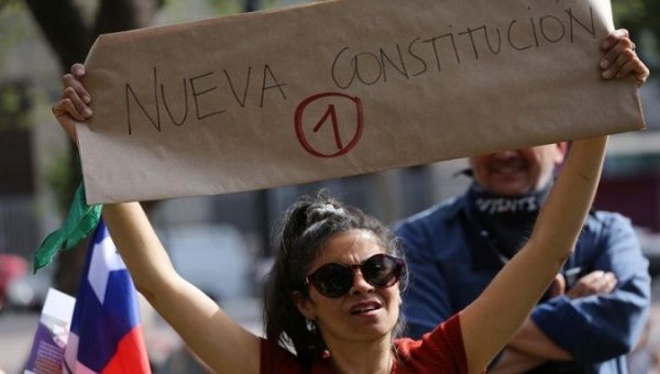 A woman demands a new constitution in Santiago, Chile, January 14, 2020.