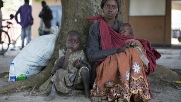 Woman and her children displaced after an armed attack in their village. Democratic Republic of Congo, August 2020.