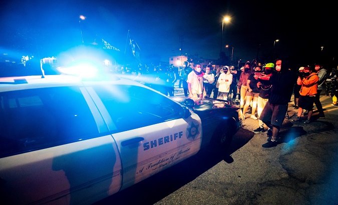 Protesters block a sheriff car on the parking lot of the Westmont Sheriff Station, Los Angeles, California. September 1, 2020.