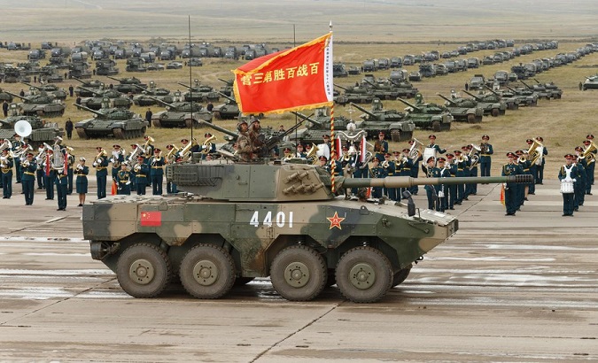 Tank passes in front of the troops in formation, China.
