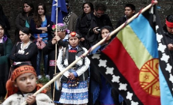 A Mapuche child waves a flag during a demonstration in Santiago, Chile, July 3, 2020.