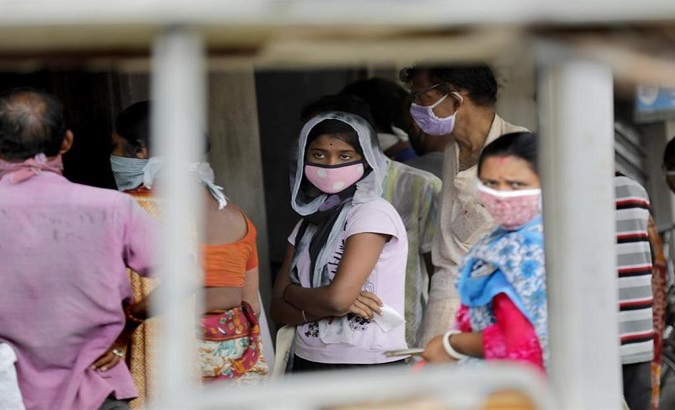 People wear face masks in a market in New Delhi, India, July 17, 2020.