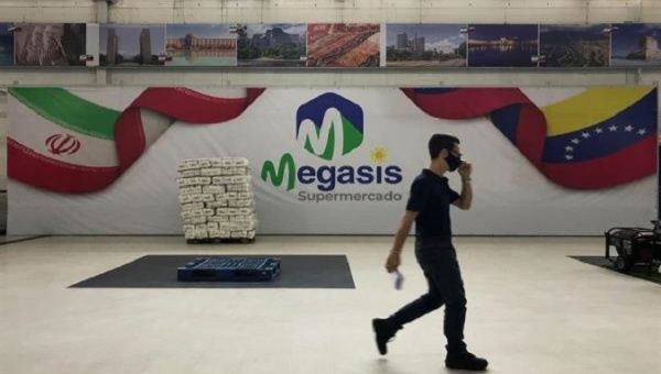 A man walks along Iran's supermarket Megasis in Caracas, Venezuela, July 31, 2020.
