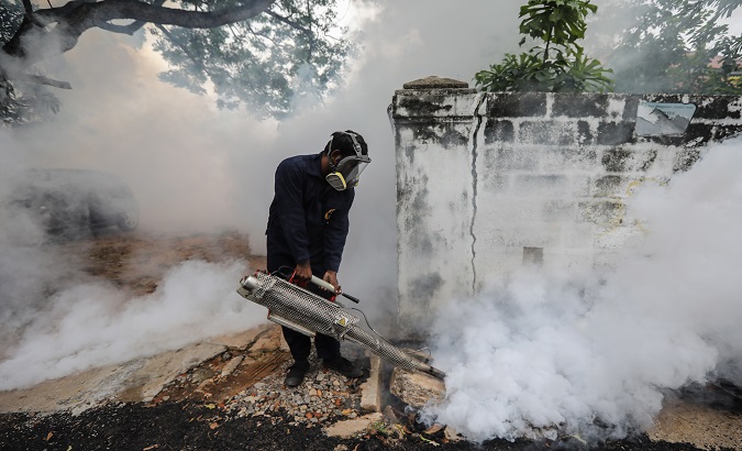 A Sri Lankan health worker fumigates insecticide to curb mosquito breeding in an attempt to control dengue fever in Colombo, Sri Lanka. September 7, 2020.