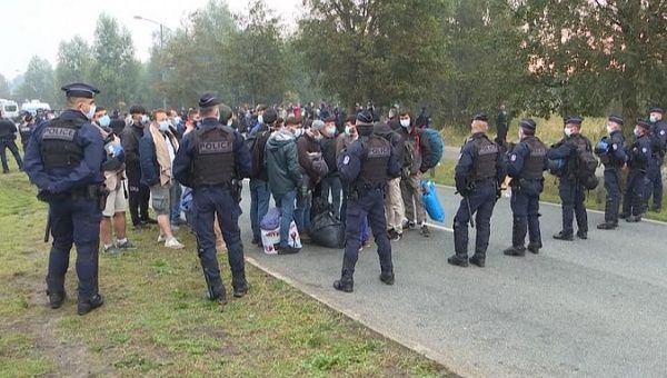 Police surround migrants in Calais, France, Sept. 29, 2020.