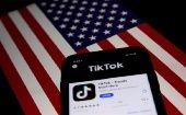 TikTok application in a phone placed in front of the U.S. flag, Sept. 24, 2020.