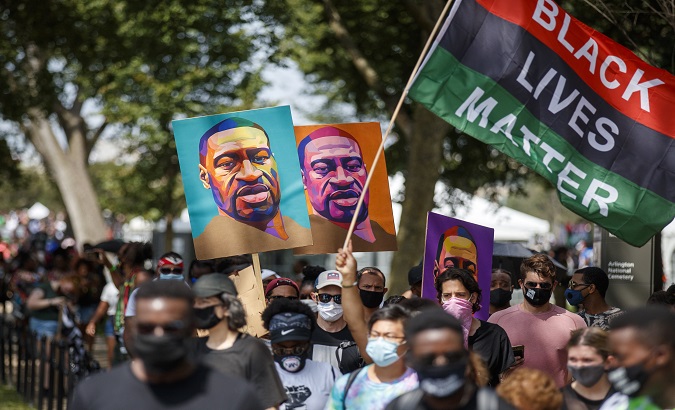 Protesters and activists carrying portraits of George Floyd attend the 'Commitment March: Get Your Knee Off Our Necks' march at the Lincoln Memorial in Washington, DC, United States.  August 28, 2020.