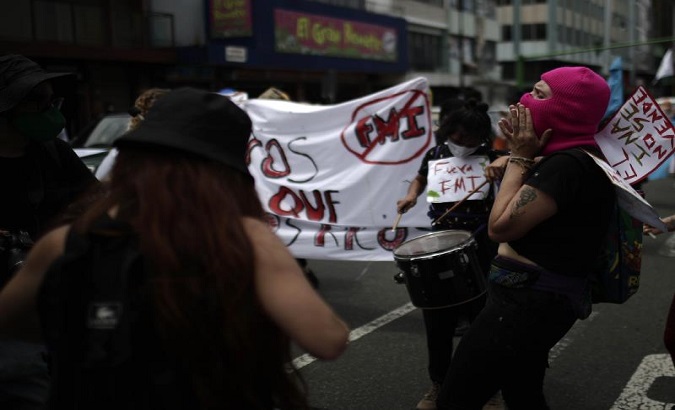 A group of people protest against the International Monetary Fund (IMF) in the streets of San Jose, Costa Rica, OCt. 7, 2020.