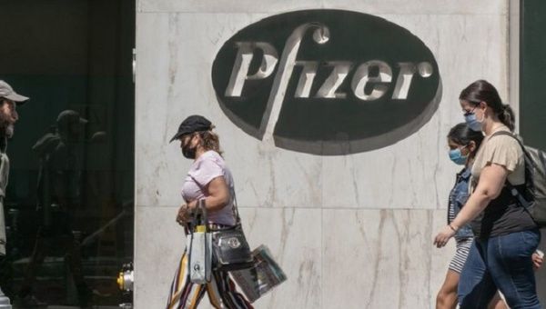 People walk in front of one of Pfizer's buildings, U.S., 2020.