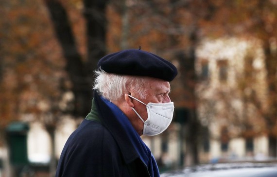 A man wearing a face mask walks along a street in Paris, France, Oct. 23, 2020.