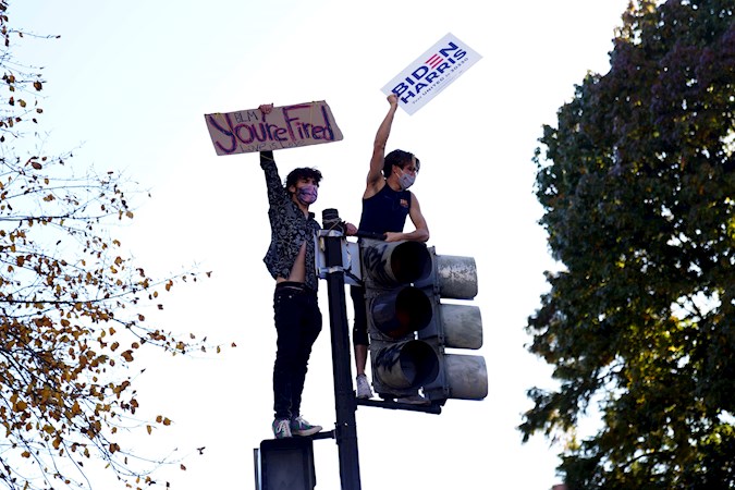 People react after major news organizations called the U.S. 2020 presidential election for Joe Biden, defeating incumbent U.S. President Donald J. Trump, near the White House in Washington, DC, USA. November 07, 2020.