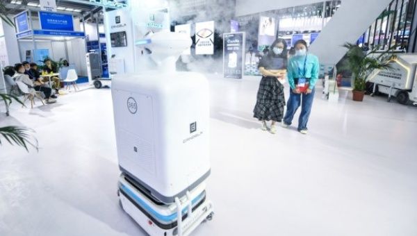 A media staff learns about the disinfection robot at the exhibition stand of the Candela Technology Innovation Co., Ltd. during the 22nd China Hi-Tech Fair (CHTF) in Shenzhen, south China, Nov. 11, 2020