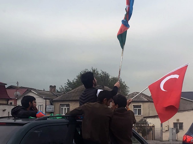 Several people celebrate from their car the end of the conflict between Azerbaijan and Armenia in the streets of Baku, the capital of Azerbaijan.