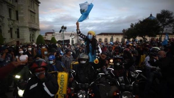 People protest in front of the Congress headquarters, Guatemala City, Nov. 22, 2020.