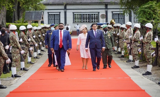 Guyana's President Irfaan Ali (L) receives honours as he arrived at the Presidential Palace, Paramaribo, Suriname, Nov. 24, 2020.