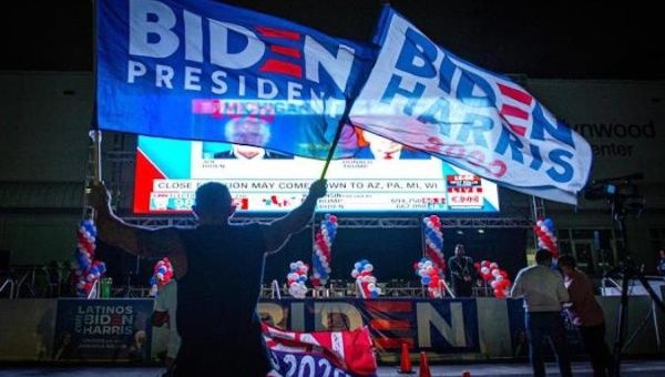 Followers of President-elect Joe Biden wave flags in Miami, Florida, U.S., Nov. 4, 2020