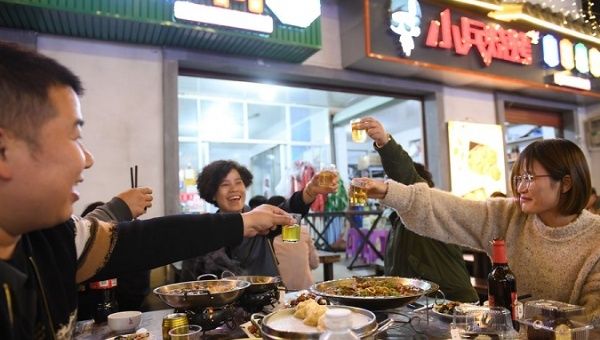 Tourists enjoy dinner at a night market in Shouchang Township of Jiande City, China, Nov. 10, 2020.