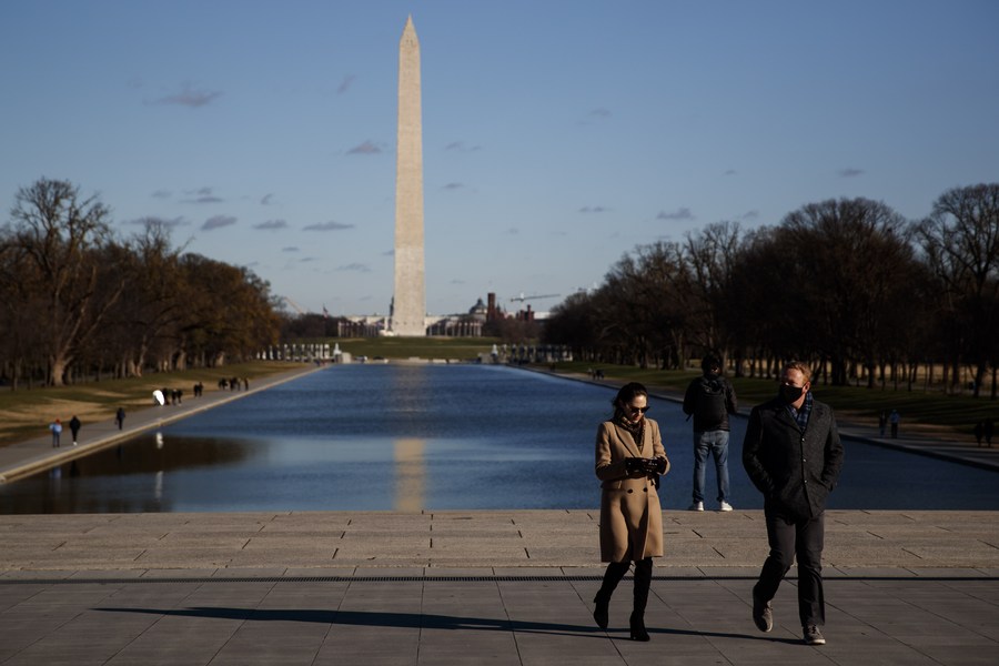 People walk on the National Mall in Washington, D.C., U.S., Dec. 17, 2020.