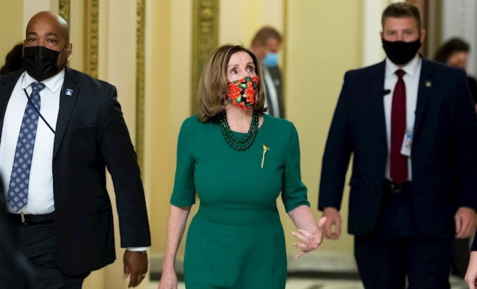 Speaker of the House Nancy Pelosi (C) walks near the House chamber on Capitol Hill, Washington, DC, U.S., Dec. 21, 2020.