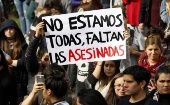 Activists take to the streets on the National Day Against Femicide, Chile, Dec. 19, 2020.The sign reads, "We are not all here, the murdered ones are missing."