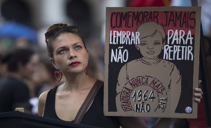 Activists mobilized to condemn the dictatorship's rule, Brazil, 2019. The sign reads, 