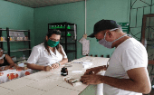 A man buys medicine in a pharmacy, Cuba, 2020.