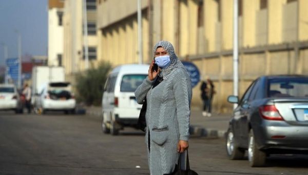 A woman walks on a street in Cairo, Egypt, Jan. 3, 2021. 