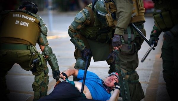 Police officers arrest a demonstrator, Chile, 2019.