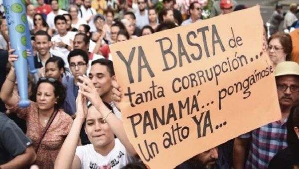 Demonstrators protest against corruption. The sing reads, 