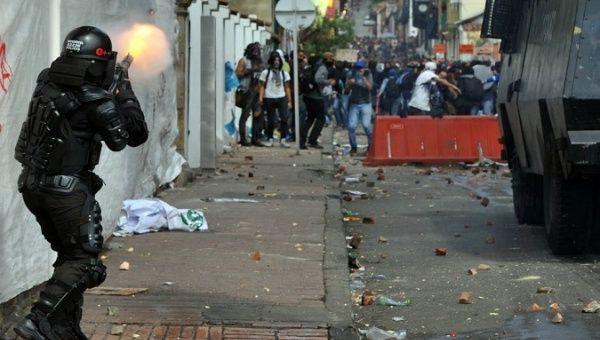A Police officer shoots demonstrators who protest Javier Ordoñez's death, Bogota, Colombia, Sept. 10, 2020.