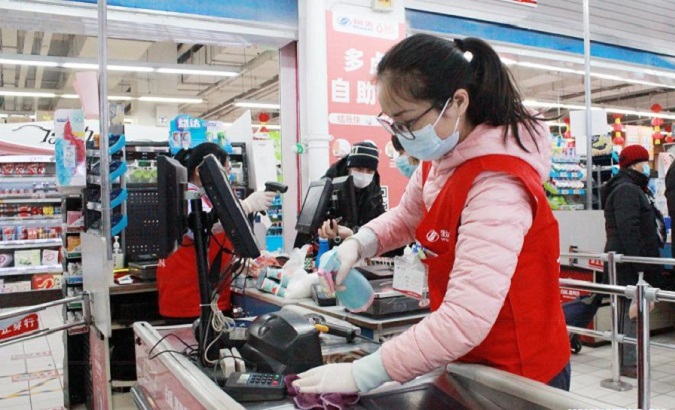 A staff member disinfects the equipment at a supermarket, Beijing, China, Jan. 6, 2021.