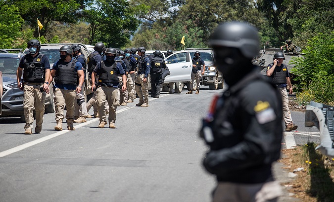 Members of the Investigative Police carry out an operation, Ercilla, Chile, Jan. 7, 2021.