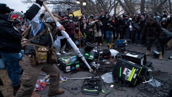 Violent protesters break TV equipment outside the Capitol on January 6, 2021, in Washington, D.C.