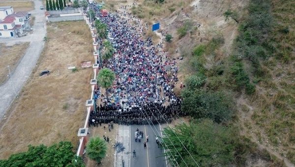 Soldiers and police form a human barricade to stop Honduran migrants walking on a highway, Guatemala, Jan. 18, 2021.