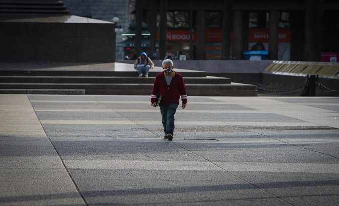 A man wearing a face mask walks in Independence Square, Montevideo, Uruguay, Jan. 17, 2021.