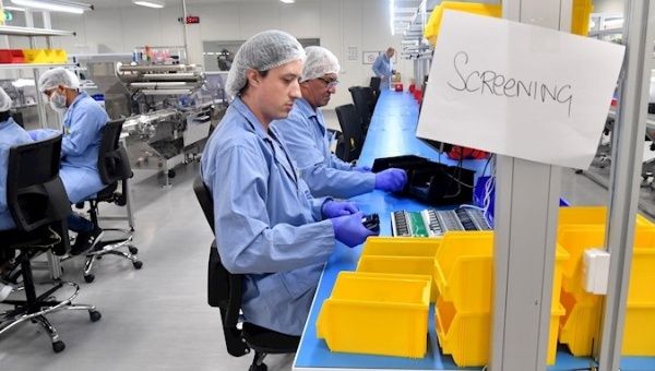 Workers in action inside the Ellume laboratory that manufactures COVID-19 home test for the U.S. Department of Defense, Brisbane, Australia, Feb. 2, 2021.