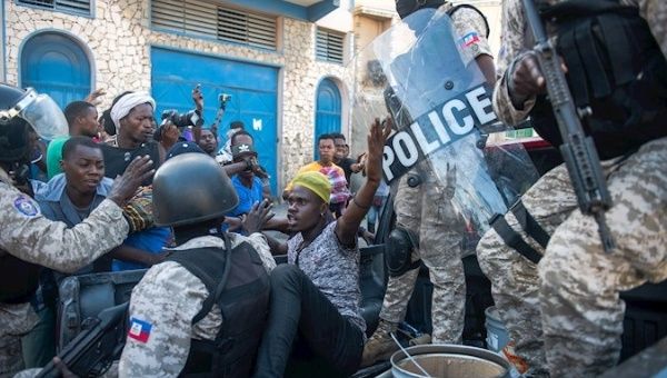 Police detain a man during protests demanding the resignation of President Jovenel Moise, Port-au-Prince, Haiti, Feb. 7, 2021. 