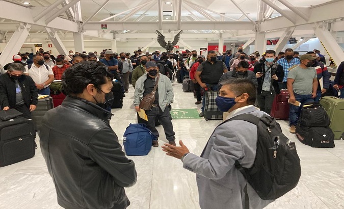 Farmworkers await a flight to Canada, Mexico, Feb. 8, 2021.