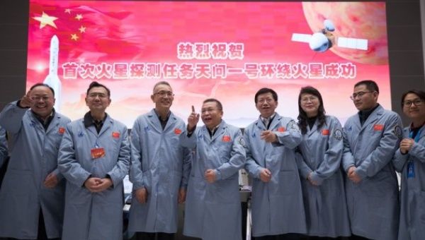 Technical personnel celebrate after China's Tianwen-1 probe successfully entered the orbit around Mars at the Beijing Aerospace Control Center in Beijing, capital of China, Feb. 10, 2021.