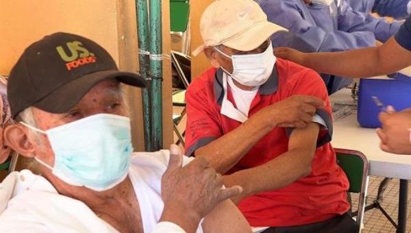 Two elderly people are vaccinated in Oaxaca, Mexico, Feb. 17, 2021.