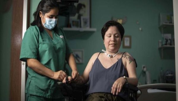 Ana Estrada is treated by a health worker, Lima, Peru, Feb. 24, 2021.
