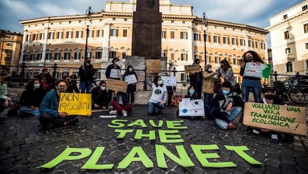 “Fridays for the Future” activists demanding to stop money for fossil sources, weapons, and major works, Rome, Italy, Feb. 19, 2021.