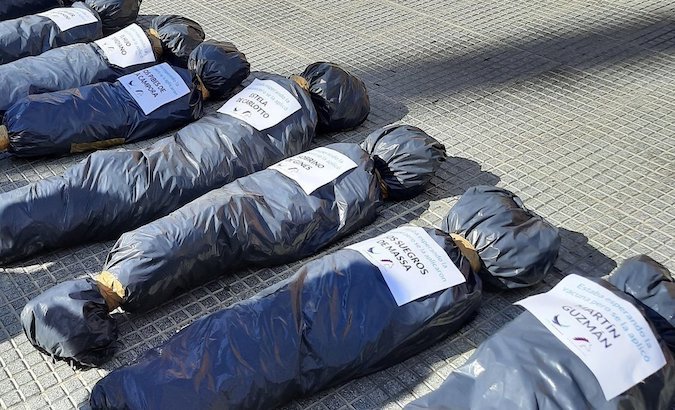 Mortuary bags with name tags of government officials and political figures, Buenos Aires, Argentina, Feb. 27, 2021.